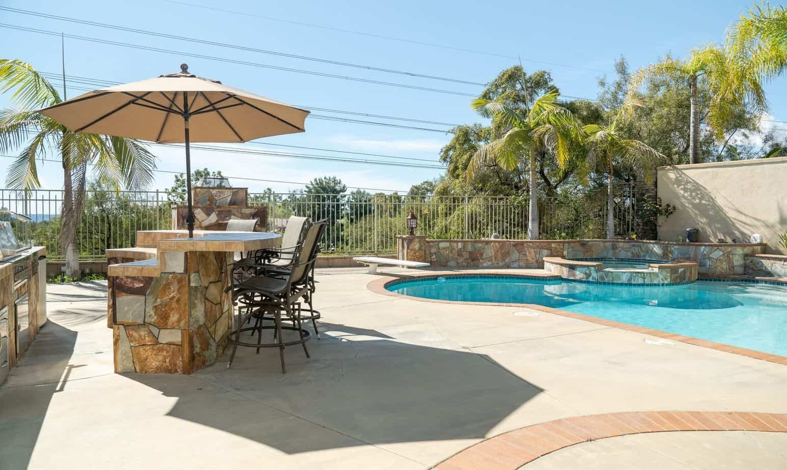 Pool and patio with shaded bar seating